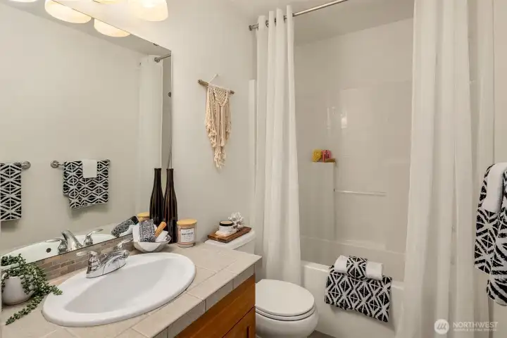 The two secondary bedrooms share this full hall bath.