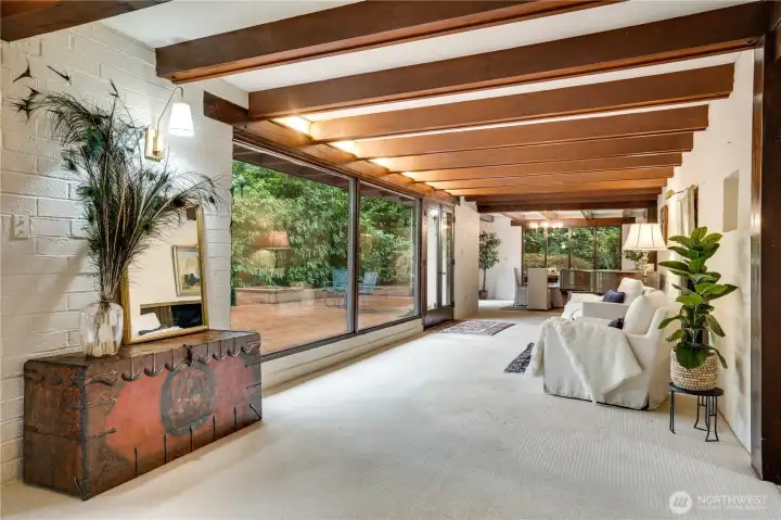 Walking straight ahead in the entry the living room & dining room are to the right.  Architectural lighting at ceiling line between the beams.