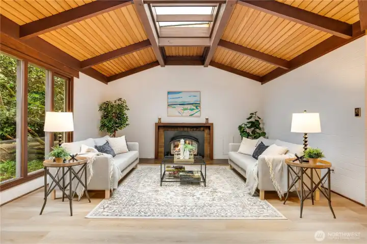 Large rec room at the end of the main floor with vaulted ceilings & gas fireplace.  Ample room for multiple seating areas & activities.