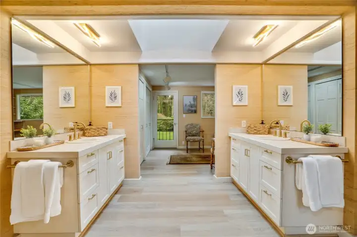 Dual vanities with large skylight tunnel above.   Dressing room beyond features 4 closets & view balcony access.