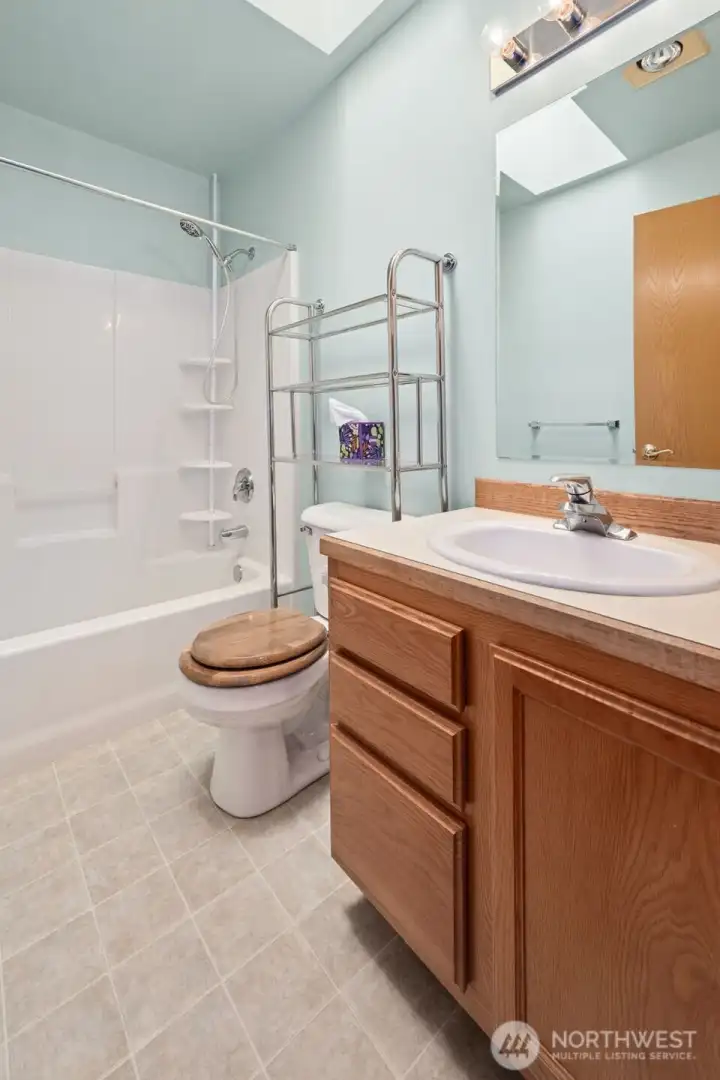 Guest bathroom with shower/tub combo and skylight to really open up the space