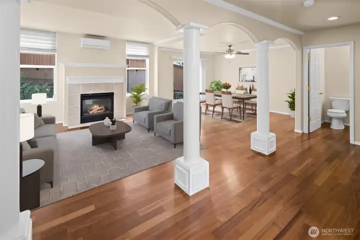 Virtually staged. View of open concept living room and dining room.