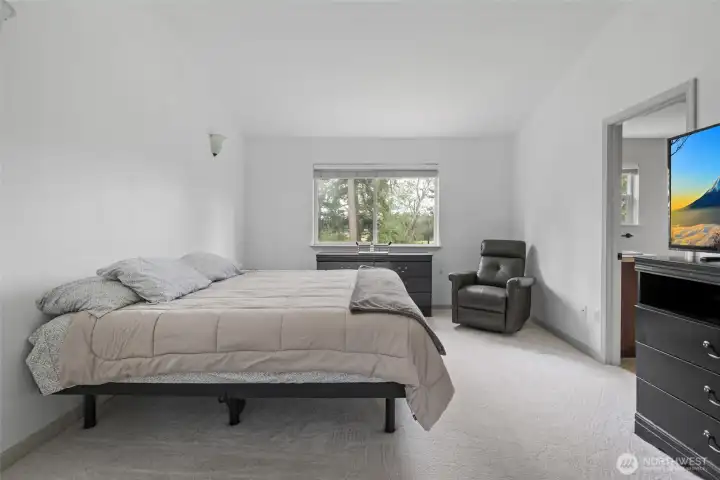 Primary bedroom with vaulted ceilings