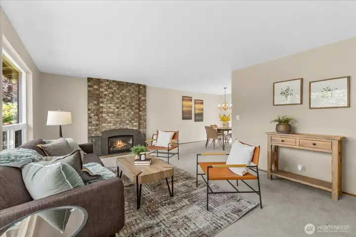 Large picture windows fill the living space with natural light, while the gas fireplace creates a warm and inviting focal point Large picture windows fill the living space with natural light, while the gas fireplace creates a warm and inviting focal point