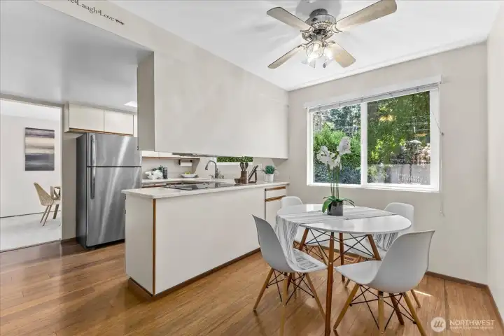 The kitchen offers a comfortable eating space surrounded by large picture windows overlooking the backyard that fill the room with natural light The kitchen offers a comfortable eating space surrounded by large picture windows overlooking the backyard that fill the room with natural light
