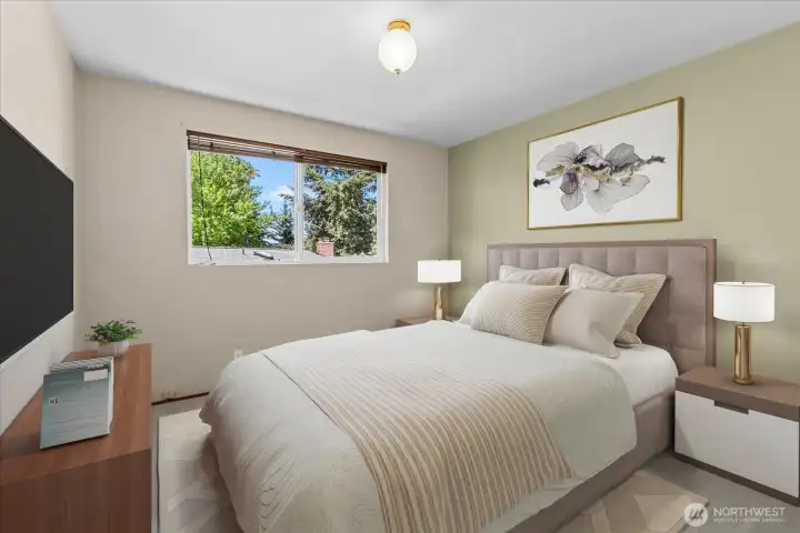 The second upstairs bedroom offers comfortable space, natural light and hardwood floors beneath the existing carpet. Virtually staged for inspiration The second upstairs bedroom offers comfortable space, natural light and hardwood floors beneath the existing carpet. Virtually staged for inspiration