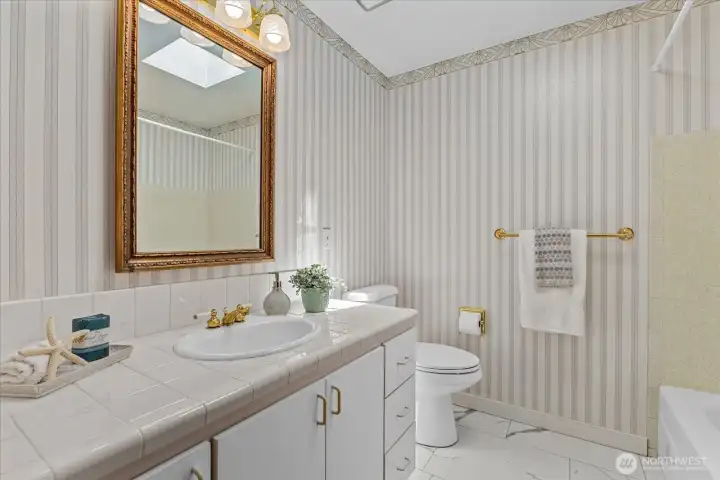 Bright full hallway bath with skylight and generous vanity space Bright full hallway bath with skylight and generous vanity space