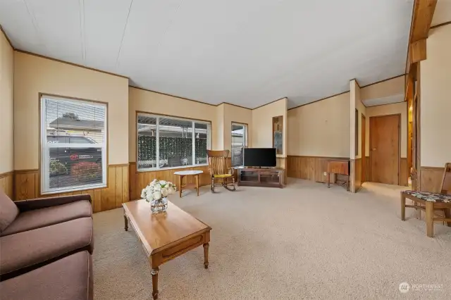 Large living room with lots of windows providing an abundance of natural light.