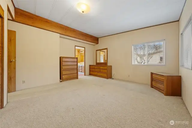 Large primary room with adjoining full bathroom.