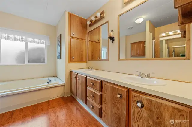 Soaking tub in Primary suite. Double sinks and lots of cabinets for storage.