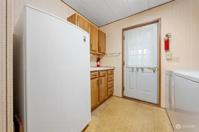 Entrance from carport. Mud room with sink. Great place for a second refrigerator.
