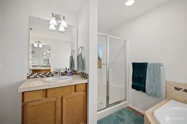 Primary bathroom features separate shower & vanities.