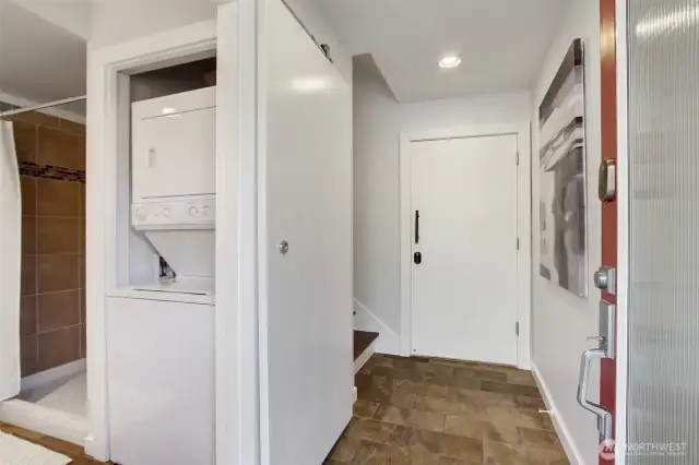 On the entry level, a 3/4 bath with laundry and access to your private garage. The sliding door maximizes space as it retracts out of the way.