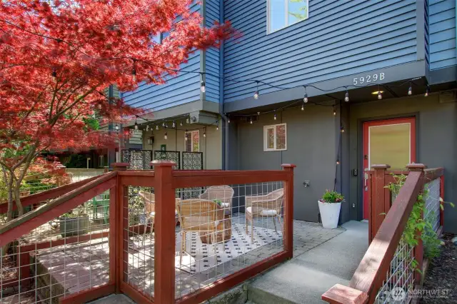 A fenced, hardscaped patio greets you as you approach this fantastic townhome set up off the sidewalk.