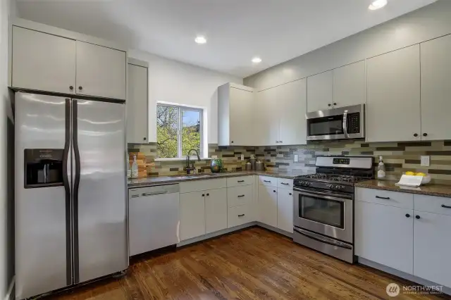 Freshly painted cabinets, new hardware and sleek appliances give this kitchen a fresh, modern vibe.