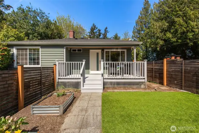 You will LOVE this covered, south-facing  porch! Ready for 4-season coffee sippin'!  Fully-fenced yard, veggie patch, low  maintence turf.