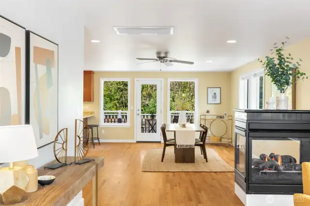 Love the connection between dining room  and living room. Cozy 2-sided gas fireplace  anchors the space.