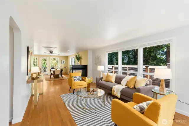 Expansive living room, dining room, and  kitchen with enchanting flow and natural  light from big windows on 3 sides! This will  be your daily hub.