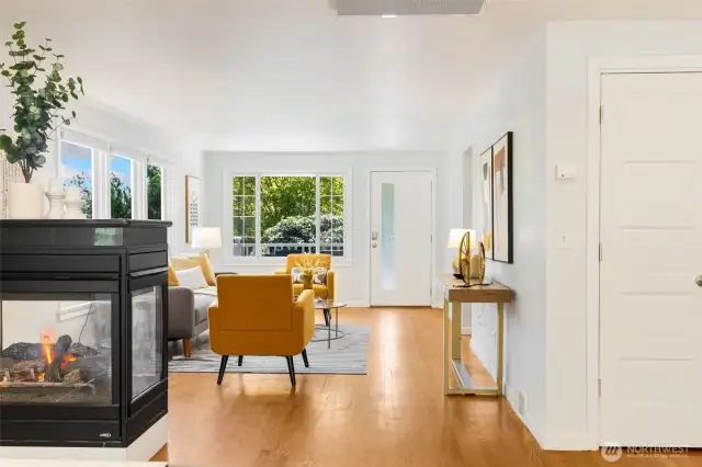 Love the connection between dining room  and living room. Cozy 2-sided gas fireplace  anchors the space.