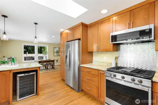 This is a serious (and seriously inspiring!)  kitchen for the home chef: abundant  cabinetry, gas range, wonderful natural light  (LOVE the skylight), and wonderful space to  spread out and create your everyday home  cooking masterpieces! Oh, yes, a wine  fridge for the celebrations.