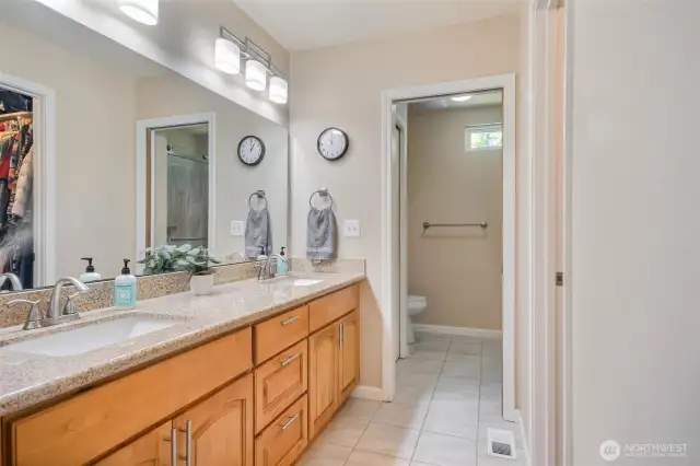 Primary bath with dual vanity, walk-in closet, and 3/4 bath