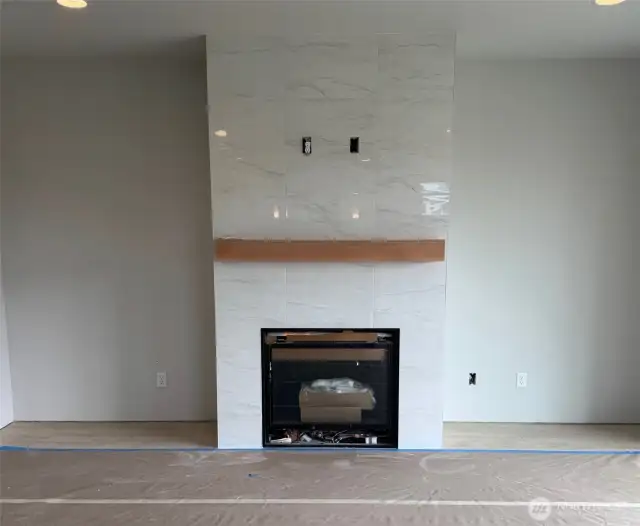 Home as of 06/25/25. Upgraded tile surround to the ceiling at the fireplace.