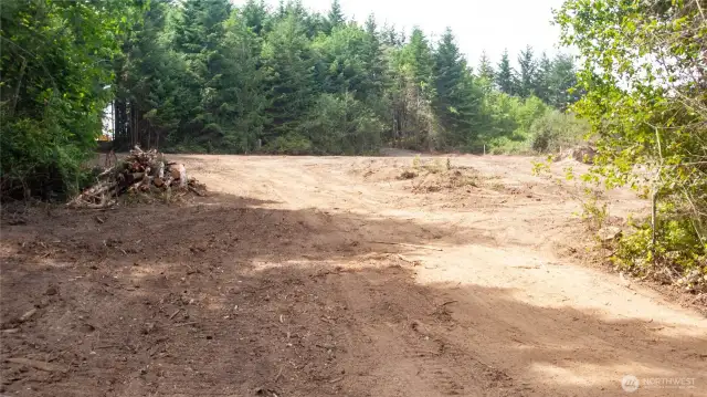 The roadway/driveway is a complete loop. This angle is looking from the southeast to northwest where the best building site has been established.