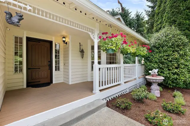 Sit out on your inviting front porch and swing while enjoying the serene views and sounds of the garden water feature.