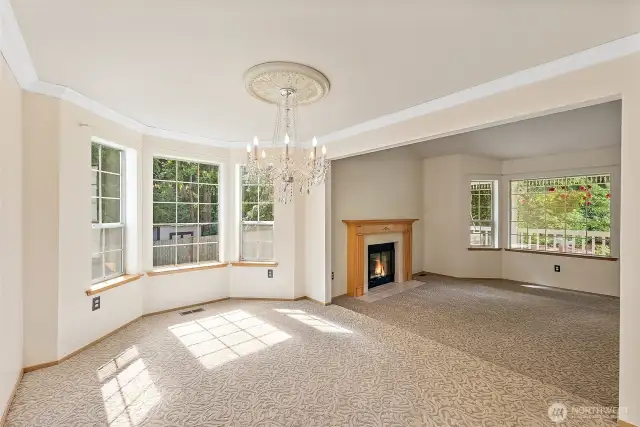 This view of the formal Dining & Living Rooms shows off the beautiful views out the large picture windows. Truly a tranquil setting, on.56 acres...