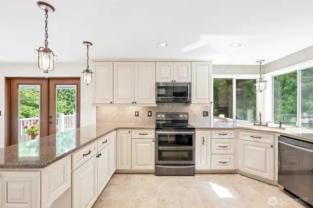 Gourmet kitchen with soft close cabinetry, glass backsplash and modern appliances