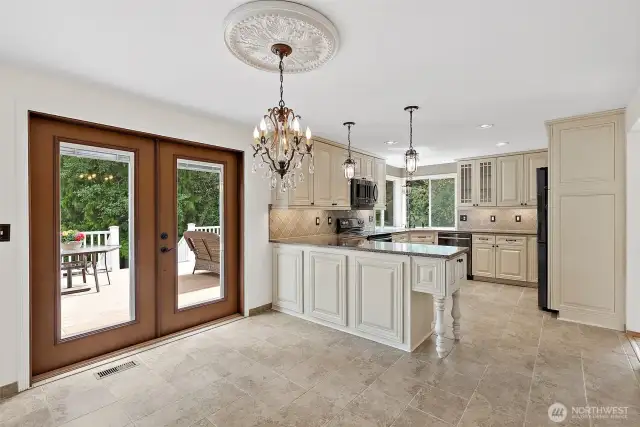 Elegant eat in kitchen dining opens to large Trex deck and backyard.