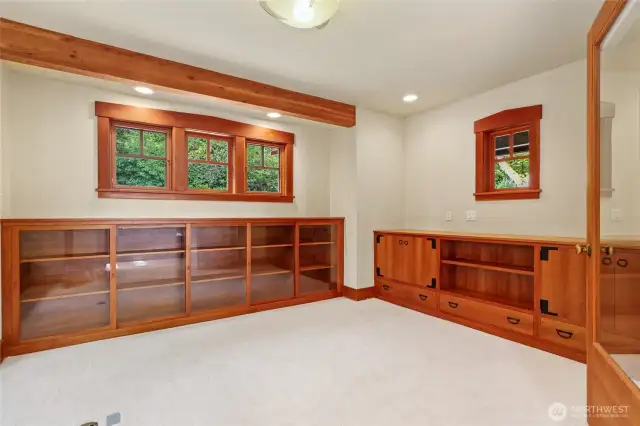 Cherry wood build ins surround this bright beautiful office/ den space.