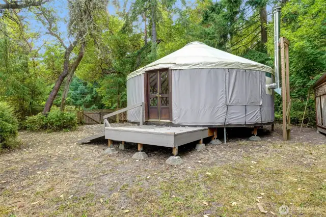Exterior view of the yurt. There is a nearby woodshed to make keeping warm easy.