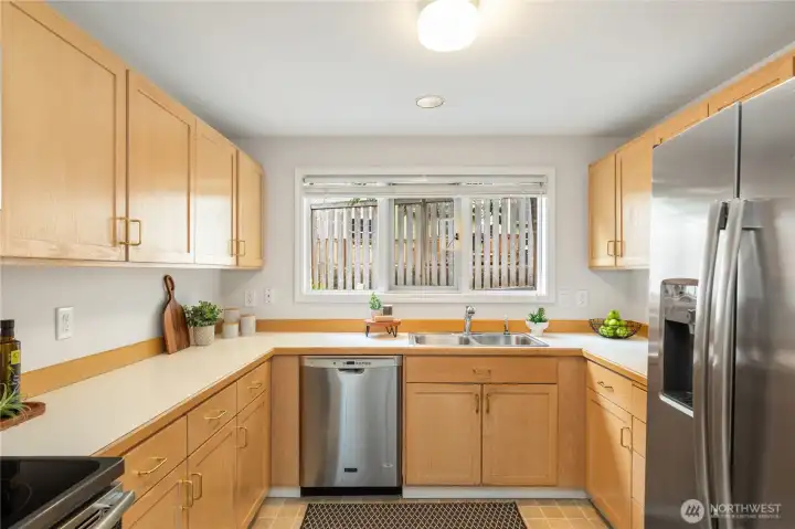 The kitchen has great storage space, including a pantry. And there is a great view from the kitchen sink out to the private backyard.