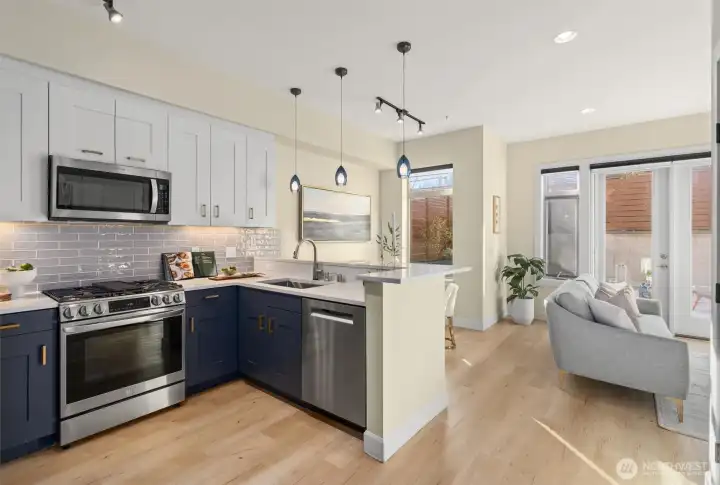 The kitchen is fabulous! Newer appliances, gas stove, beautiful glass backsplash with under cabinet lighting. Slab quartz countertops and eating bar!