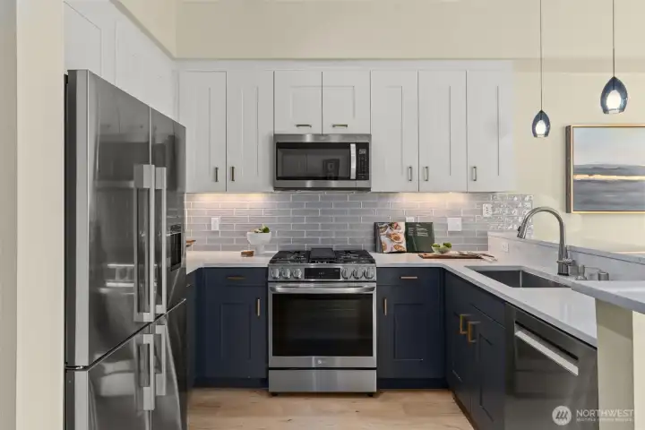 The kitchen is fabulous! Newer appliances, gas stove, beautiful glass backsplash with under cabinet lighting. Slab quartz countertops and eating bar!