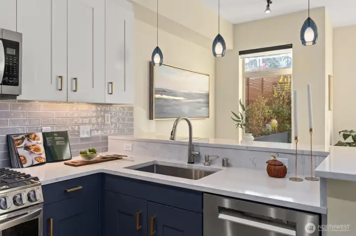 The kitchen is fabulous! Newer appliances, gas stove, beautiful glass backsplash with under cabinet lighting. Slab quartz countertops and eating bar!