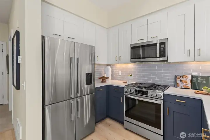 The kitchen is fabulous! Newer appliances, gas stove, beautiful glass backsplash with under cabinet lighting. Slab quartz countertops and eating bar!