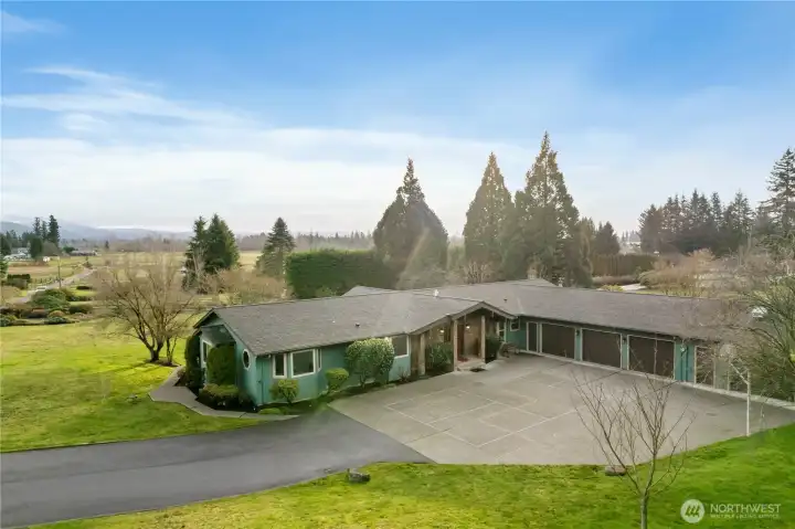 Conveniently located near Enumclaw's historic Krain Corner district with a private paved road leading you to this 4 bedroom/3 bath home. Clean concrete driveway hosts a painted pickle ball court for exercise and fun.  Major feature an attached 3 bay garage with a wall-off 4th bay is walled off from the main garage and is set up as a work shop.