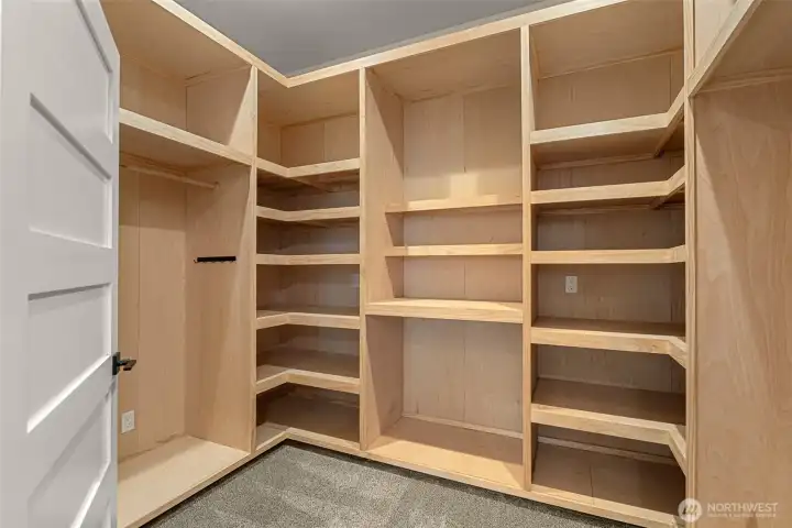 Primary walk-In closet with organizational system.