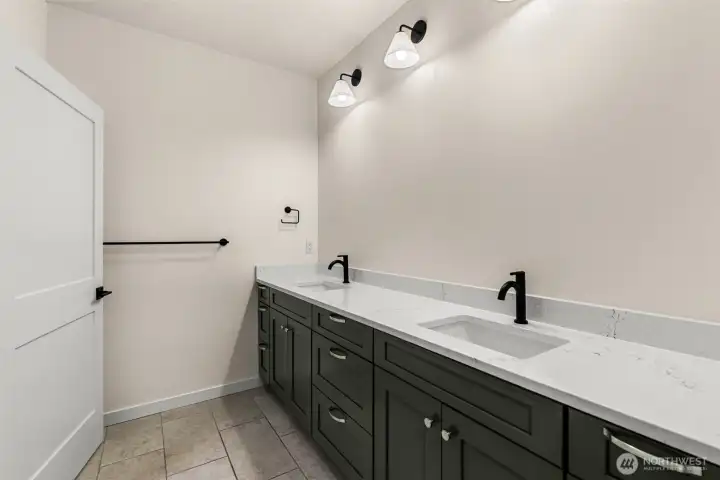 Nicely sized lower level full bath with separate private dual vanity from water closet/tub/shower