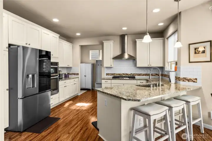 Stainless steel appliance in kitchen. New fridge and stove top