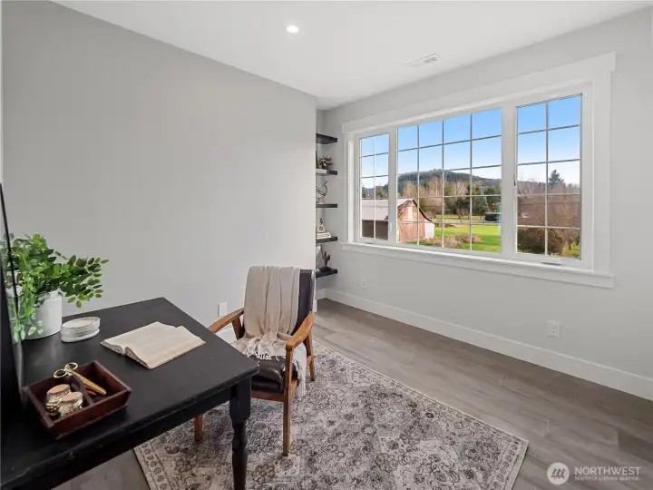 Office with Cascade Foothills views & built-in shelving.