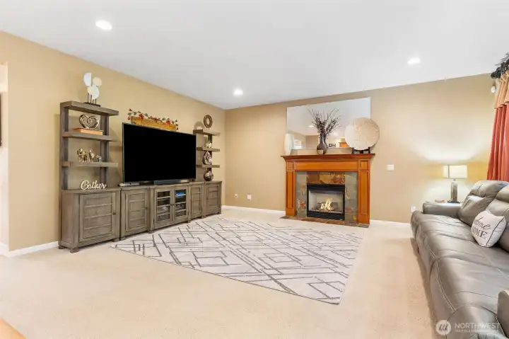 Great room concept with focal gas fireplace and wood mantle. Surround sound.
