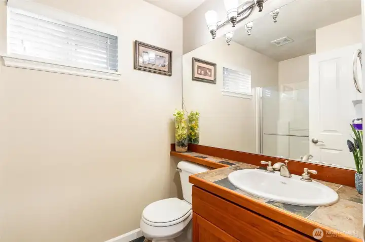 Main floor guest bathroom. See the shower in the mirror?