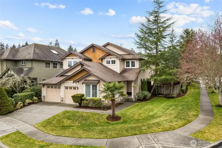 Corner lot view. Professionally landscaped with sprinkler system, fenced yard with double gates.