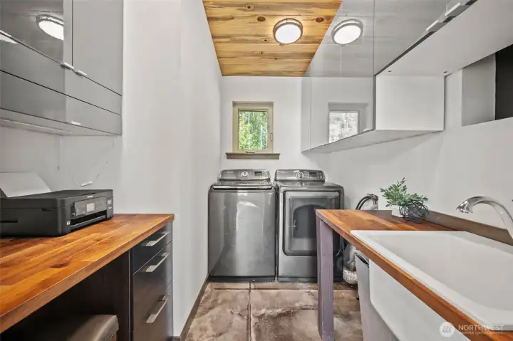 Thoughtfully designed laundry room with built in desk space.