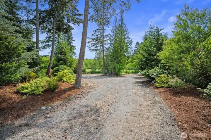 The spacious driveway offers many parking areas, as well as a roundabout.