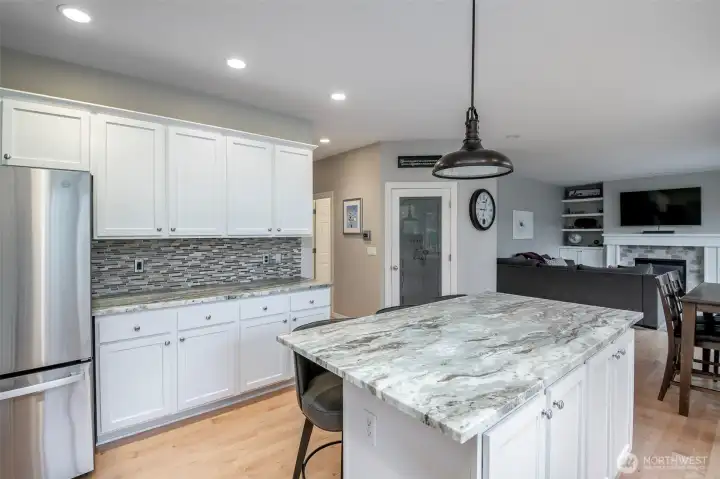 Expansive slab granite countertops offer both beauty and functionality, with ample space for meal preparation and entertaining guests Expansive slab granite countertops offer both beauty and functionality, with ample space for meal preparation and entertaining guests