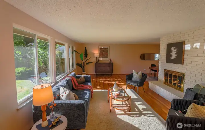 Spacious living room with lots of west facing natural light and a cozy wood burning fireplace